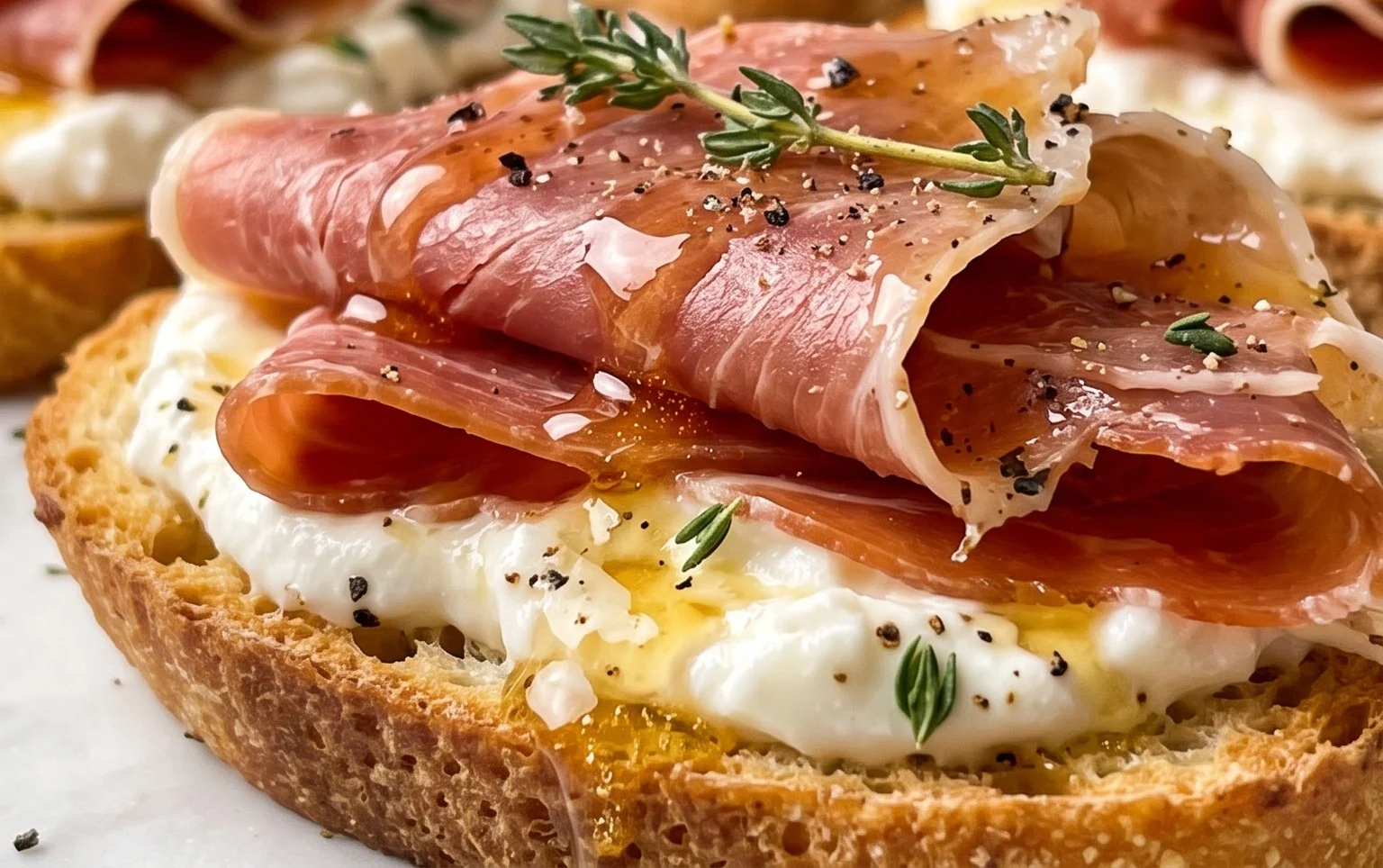 Beef Prosciutto Crostini with Burrata and Lemon Honey Drizzle